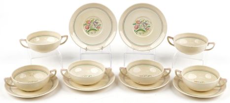 Set of six Susie Cooper twin handled soup bowls and saucers decorated with stylised flowers, each