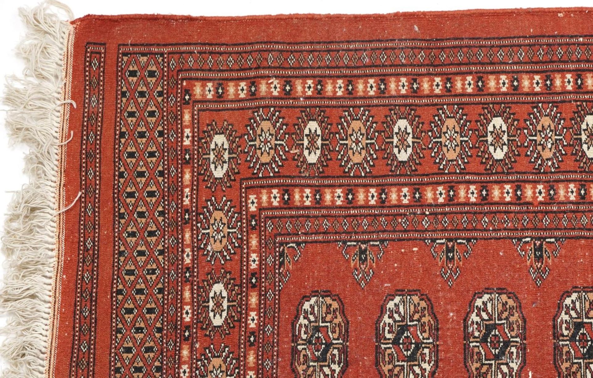 Rectangular Turkish Bokhara peach ground rug having an allover repeat flower head design, 150cm x - Image 4 of 4