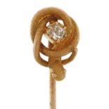 Unmarked gold and yellow metal diamond solitaire stickpin in the form of a serpent, the serpent