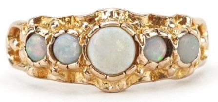 Victorian style cabochon opal five stone ring with ornate setting, the largest opal approximately