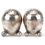 Robert Stebbings, pair of Victorian silver egg shape casters with ball feet, London 1895, each 3.8cm