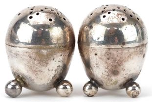 Robert Stebbings, pair of Victorian silver egg shape casters with ball feet, London 1895, each 3.8cm