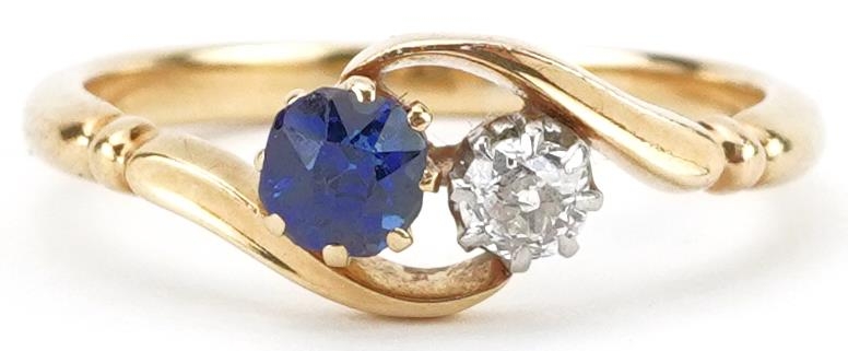 Unmarked gold diamond and sapphire crossover ring, tests as 18ct gold, the diamond approximately 0.