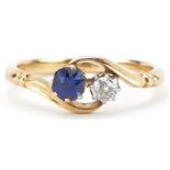 Unmarked gold diamond and sapphire crossover ring, tests as 18ct gold, the diamond approximately 0.