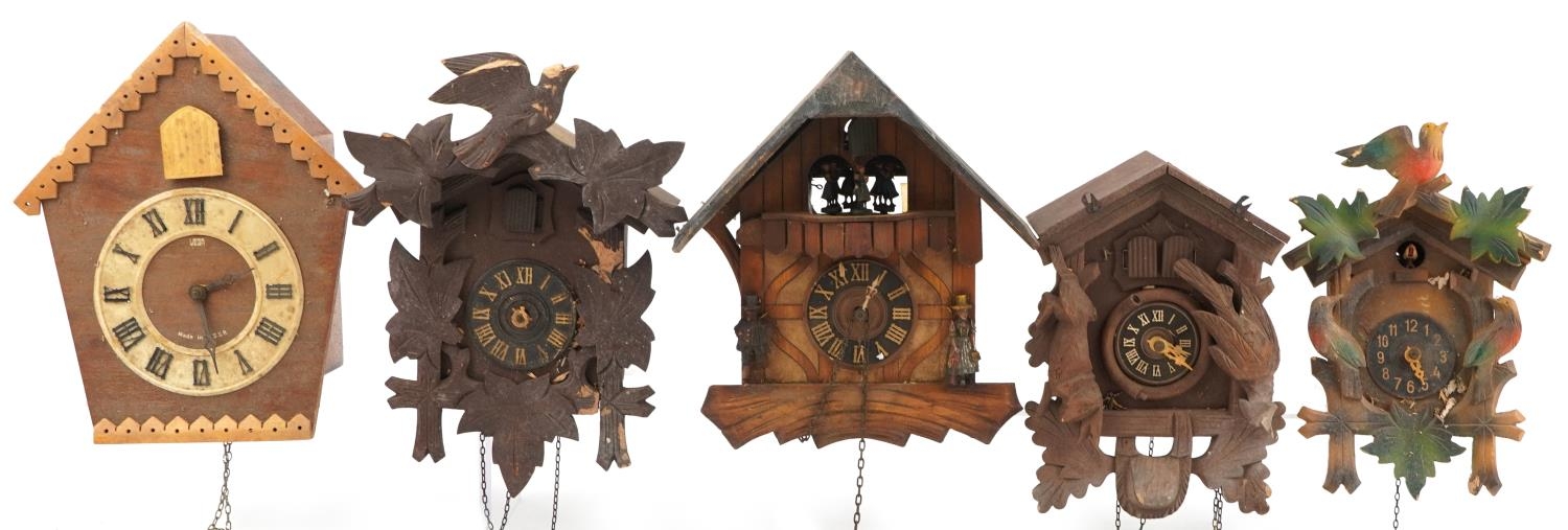 Four German carved Black Forest cuckoo clocks and a Russian USSR example by Veaga, the largest