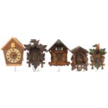 Four German carved Black Forest cuckoo clocks and a Russian USSR example by Veaga, the largest