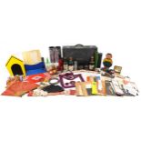 Collection of vintage magician tricks and props including tinplate bottles, playing cards, cups &