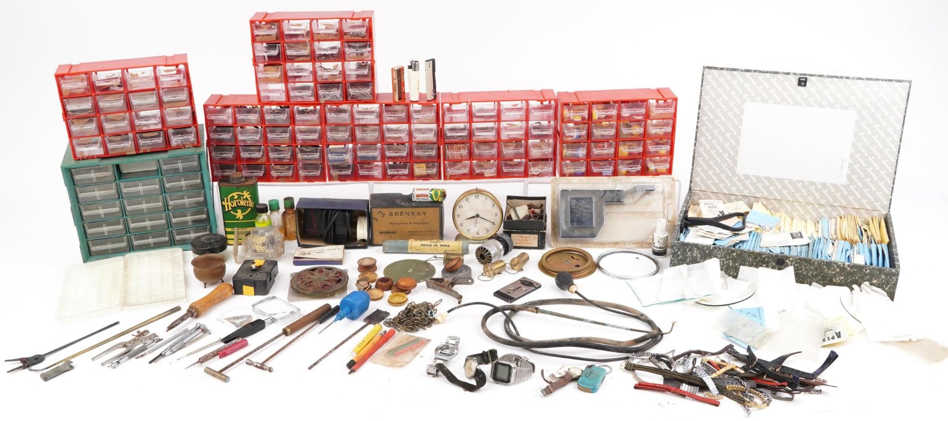 Collection of horological interest clock and watchmaker's parts, predominantly arranged in drawers