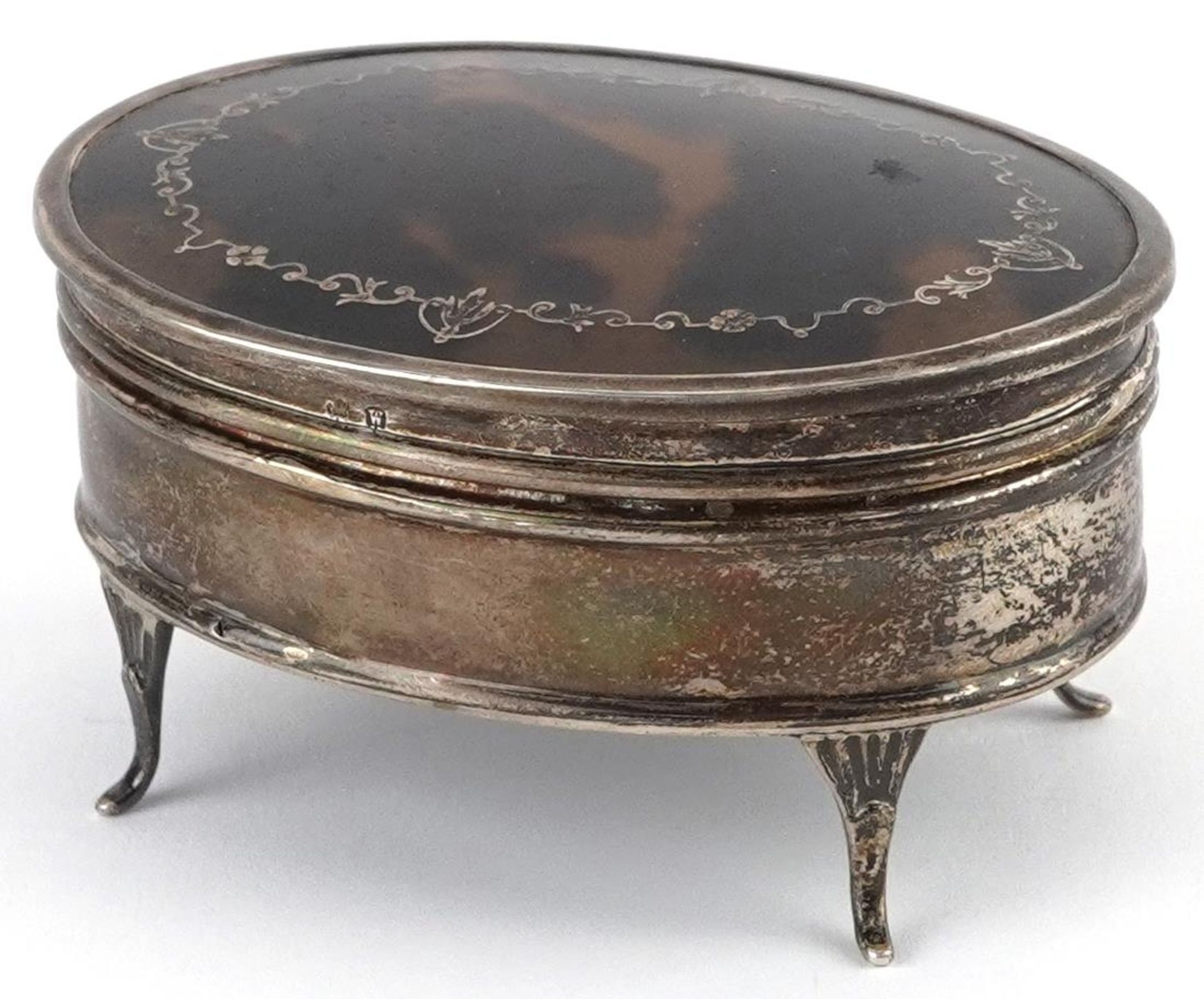 E S Barnsley & Co, George V silver and tortoiseshell pique work jewel box raised on four feet,