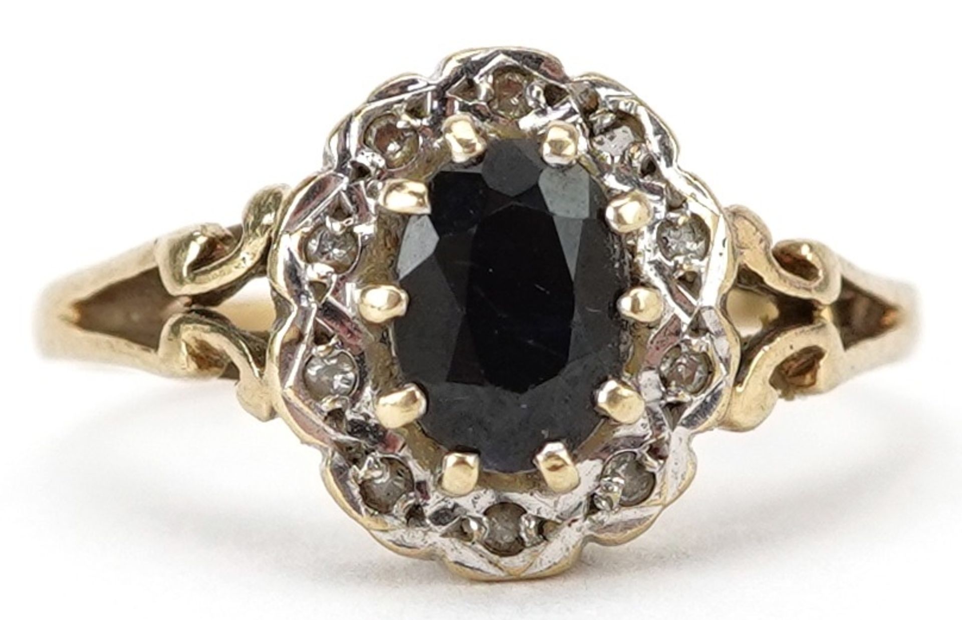 9ct gold sapphire and diamond cluster ring with pierced shoulders, the sapphire approximately 7.