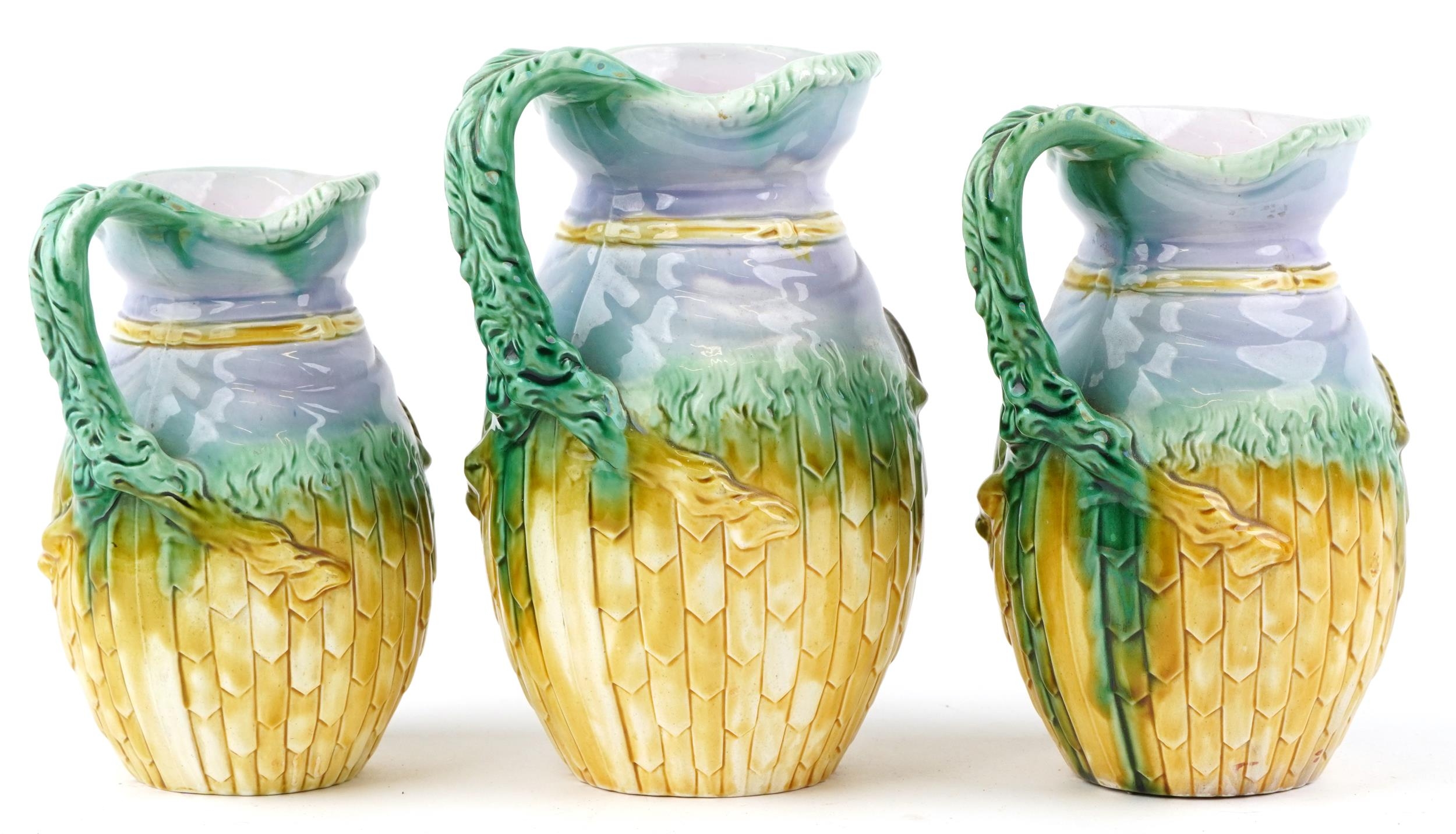 Graduated set of three Majolica jugs, each decorated in relief with a ram's head, the largest 22.5cm - Image 2 of 4