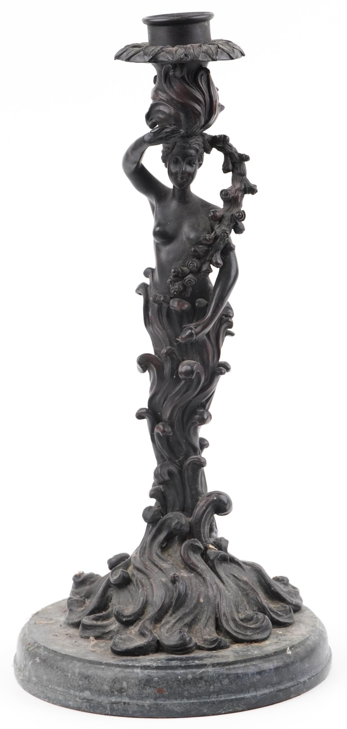 Classical patinated bronze candlestick in the form of a semi nude female on waves, raised on a