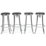 Set of four industrial chromed bar stools with black upholstered cushioned seats, 69cm high