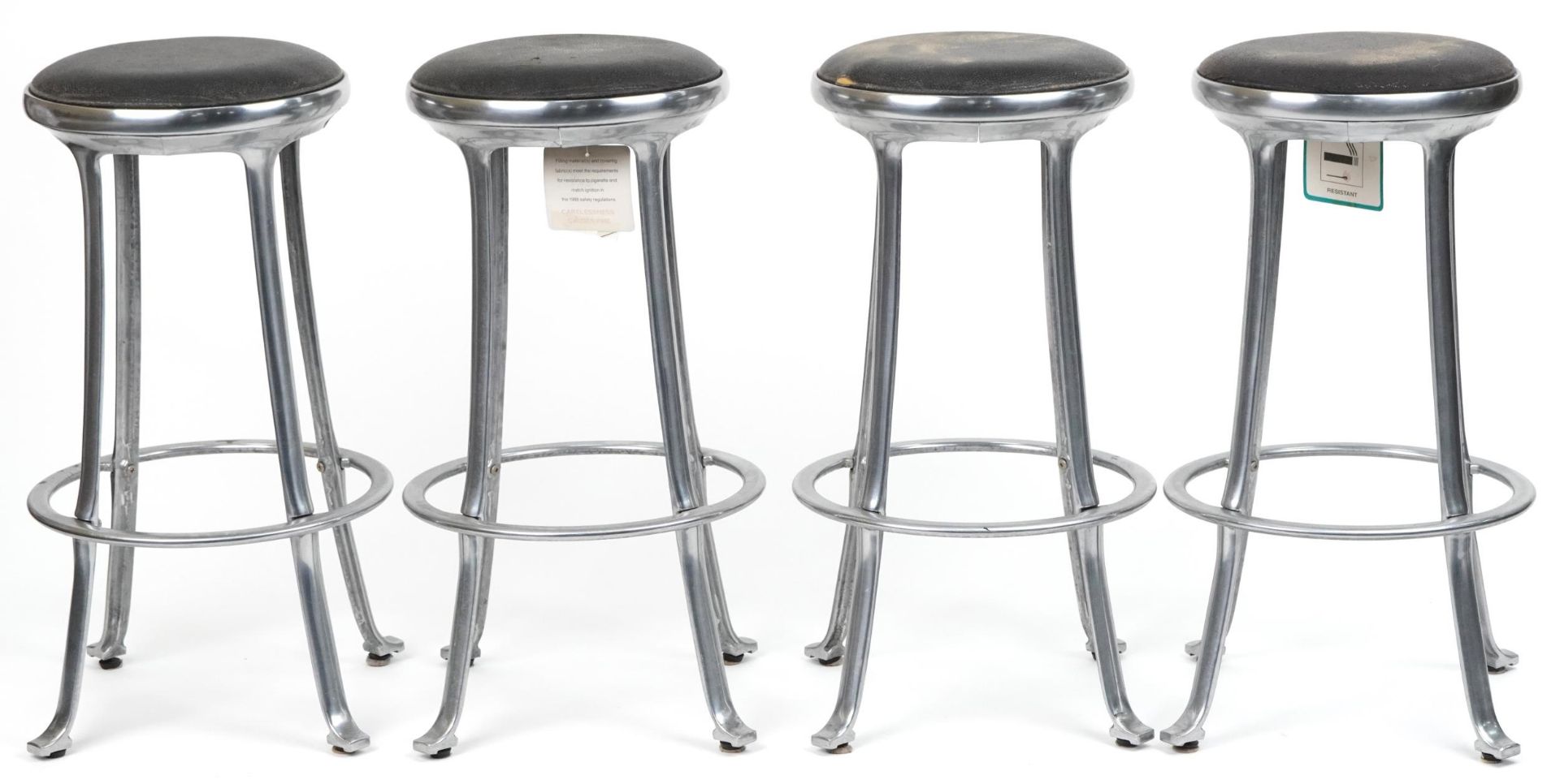 Set of four industrial chromed bar stools with black upholstered cushioned seats, 69cm high