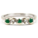 18ct white gold diamond and emerald five stone crossover ring, size N, 2.3g