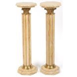 Pair of classical Travertine marble pedestal columns with gilt metal mounts, each 103cm high