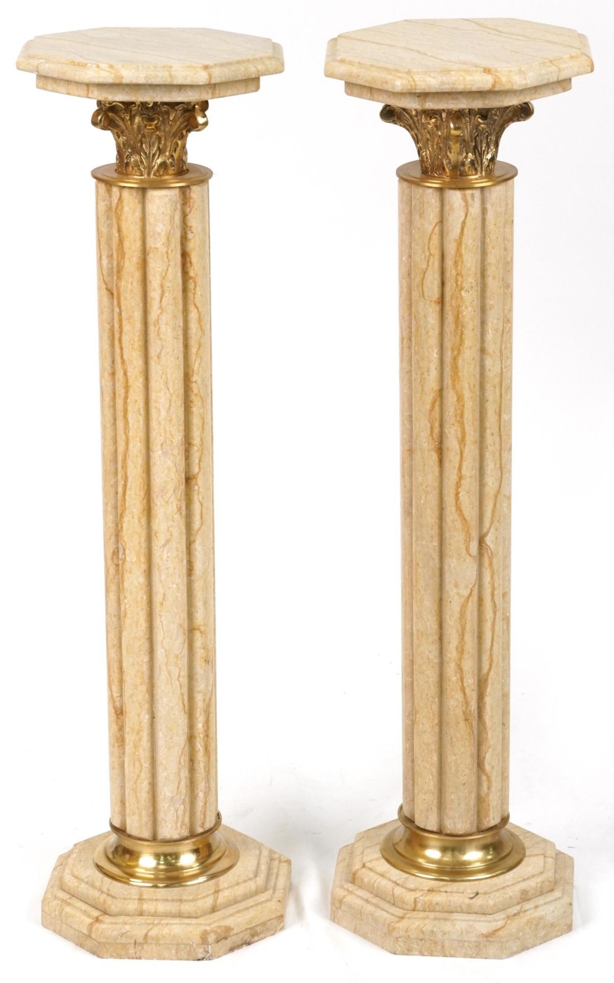 Pair of classical Travertine marble pedestal columns with gilt metal mounts, each 103cm high