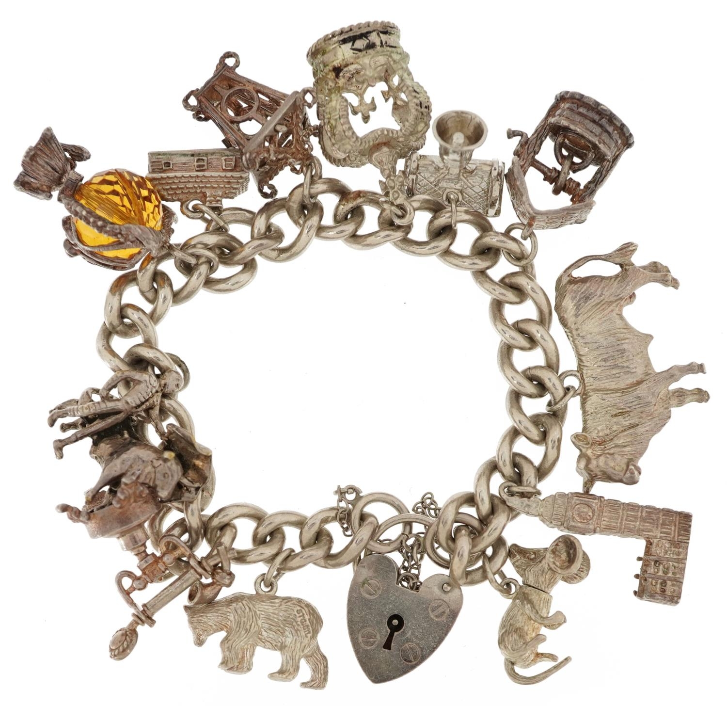 Silver charm bracelet with love heart padlock and a collection of mostly silver charms, including