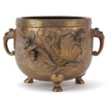 Japanese patinated bronze three footed censer with twin handles decorated in relief with serpents