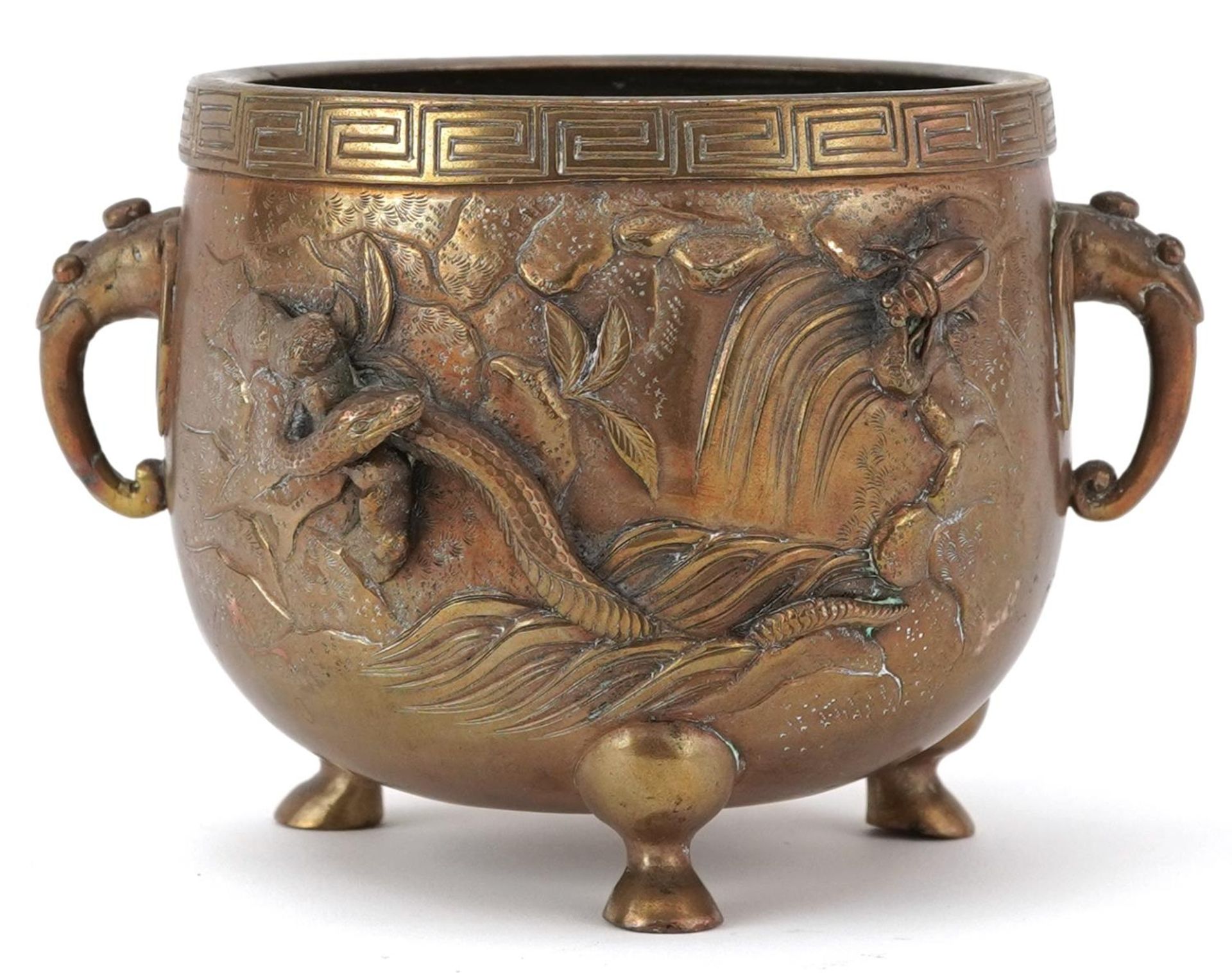 Japanese patinated bronze three footed censer with twin handles decorated in relief with serpents