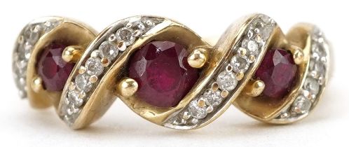 9ct gold diamond and ruby crossover ring, total diamond weight approximately 0.10 carat, the largest