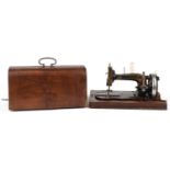 Victorian cast iron sewing machine with case, the sewing machine numbered 2004356, the case 40.5cm