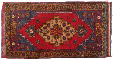 Rectangular Persian red and blue ground rug having an allover repeat floral design, 101cm x 52cm