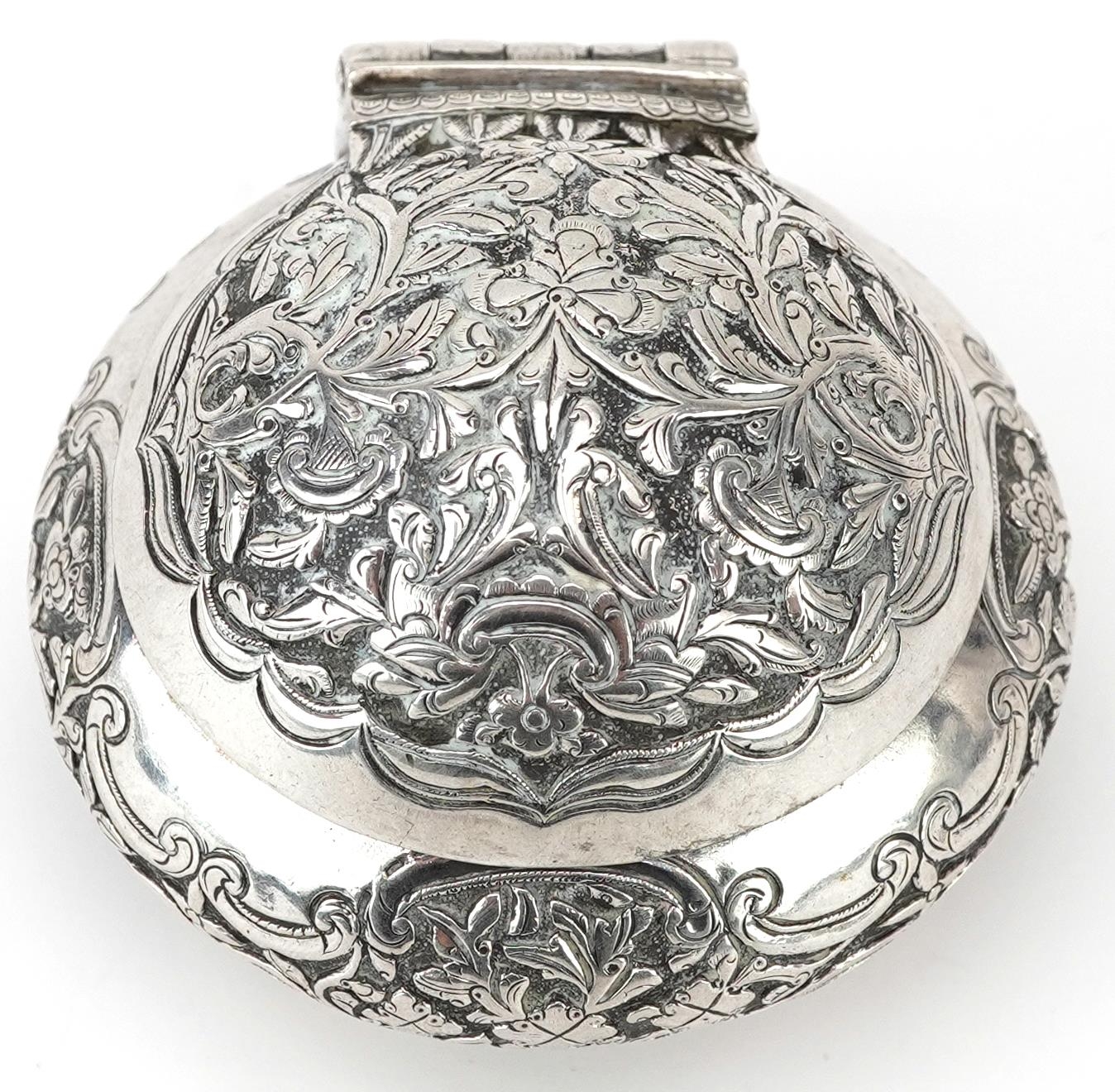 Tibetan unmarked silver bun shaped box with hinged lid profusely embossed with flowers and - Image 2 of 5