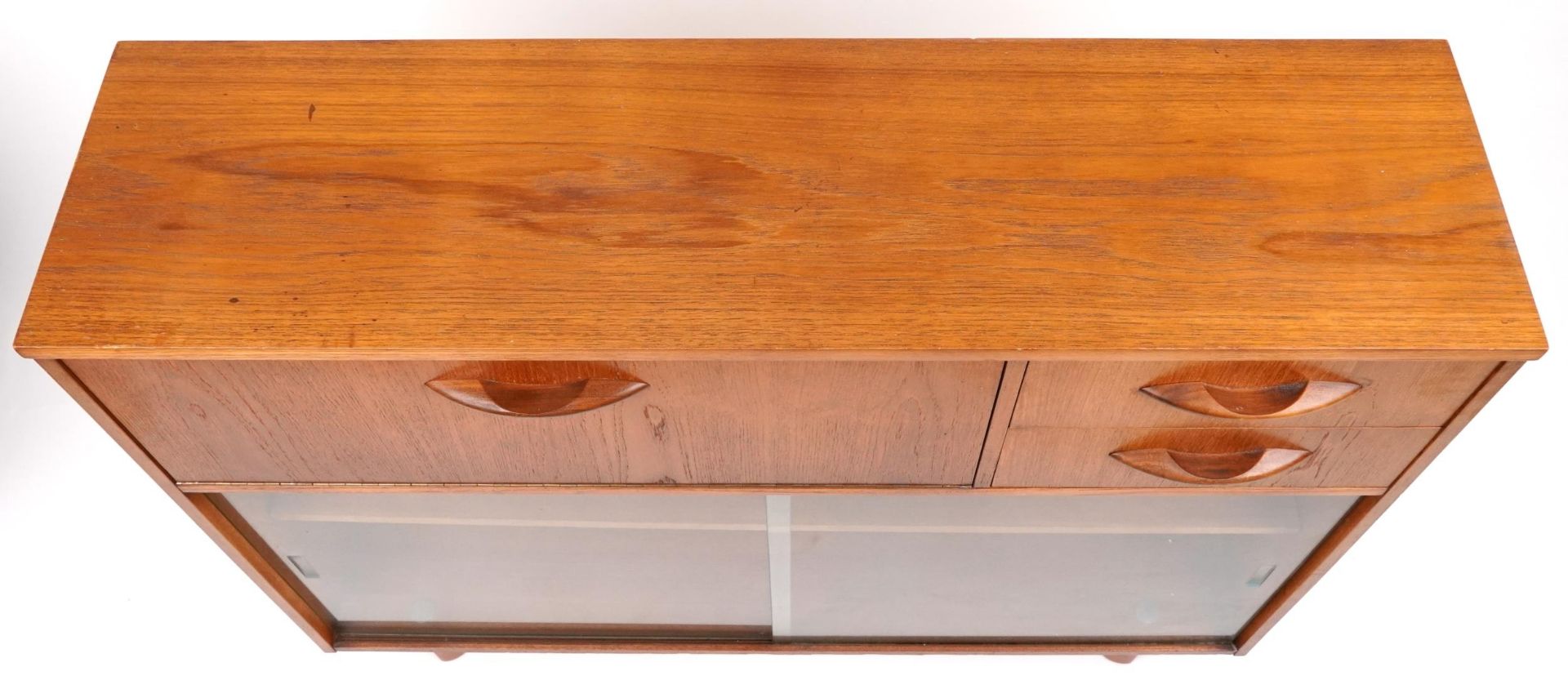Avalon, mid century teak side cabinet fitted with a fall and two drawers above a pair of glass - Image 3 of 5