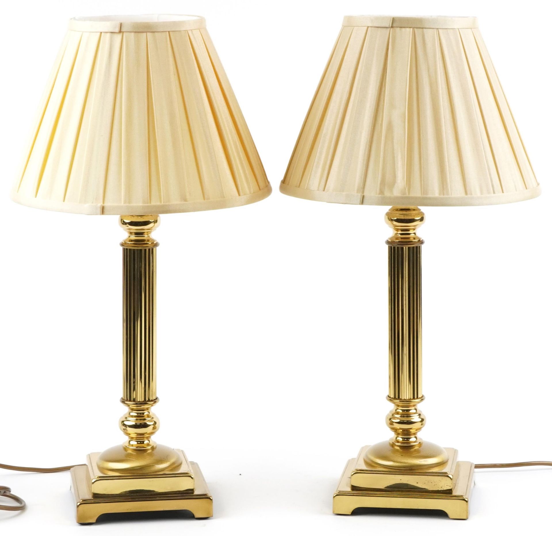 Pair of classical brass Corinthian column table lamps with stepped square bases and silk lined