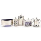 Five Art Deco and later silver cruet items, four with blue glass liners, the largest 9cm wide,