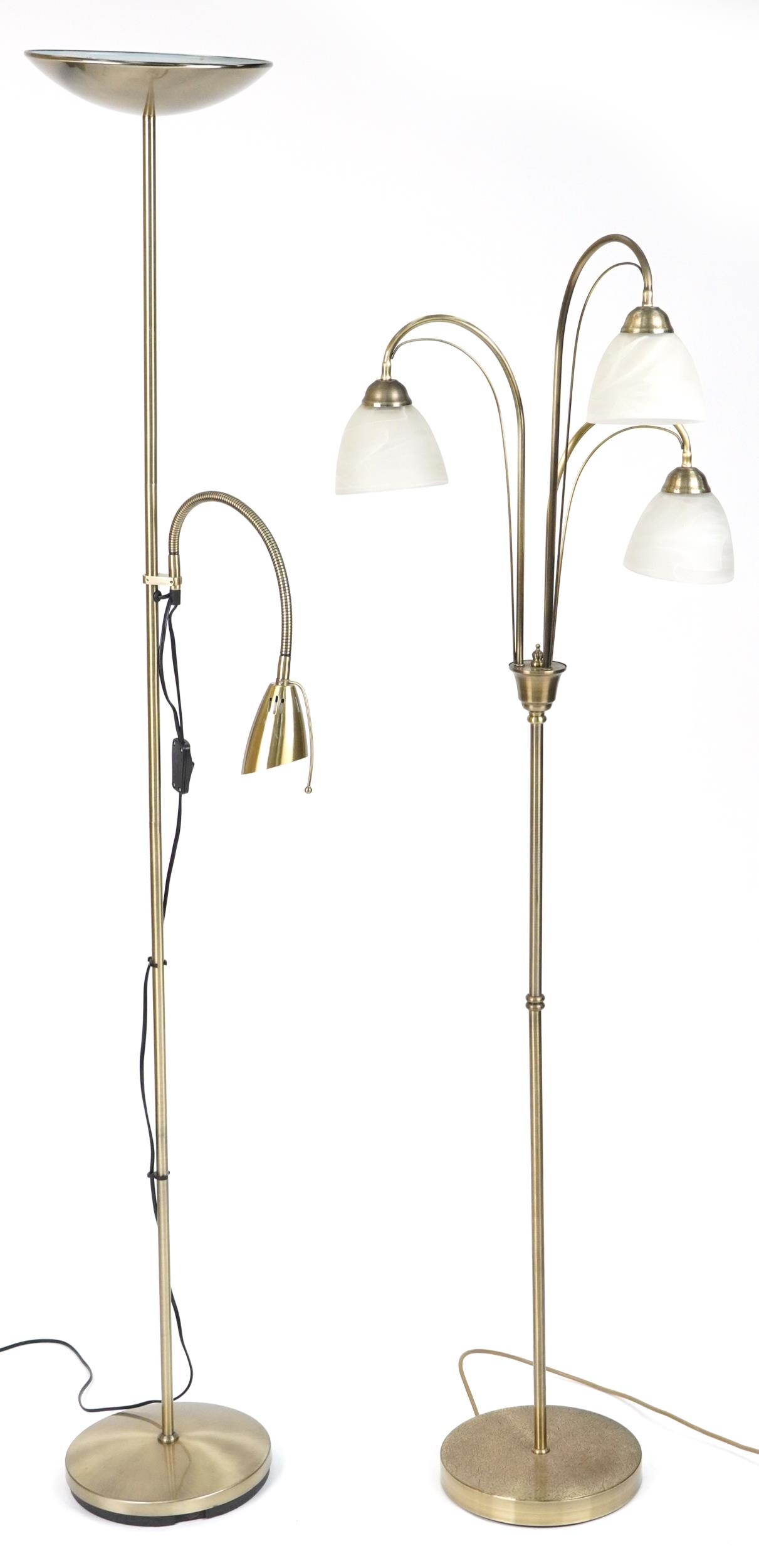 Two brass standard lamps including a three branch example with frosted glass shades, 179.5cm high