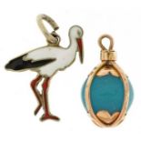 Two charms comprising Danish sterling silver and enamel stork from Ribe and an unmarked gold caged