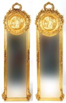 M pair of French Empire style ornate gilt framed wall mirrors with wreath crests and bevelled glass,