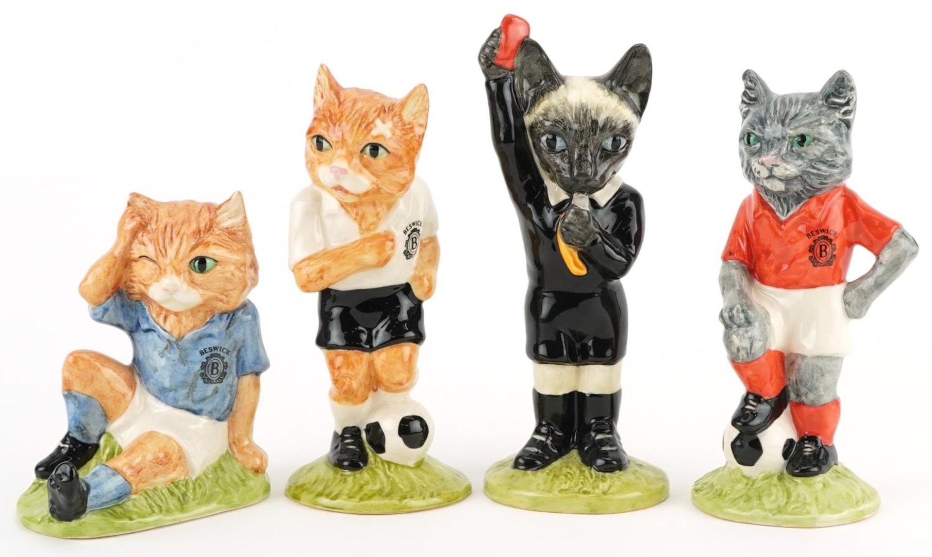 Four sporting interest Beswick cat figures from the Footballing Felines Collection comprising