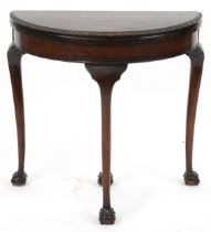 Georgian style mahogany demi lune fold over card table with green baize lined interior on cabriole