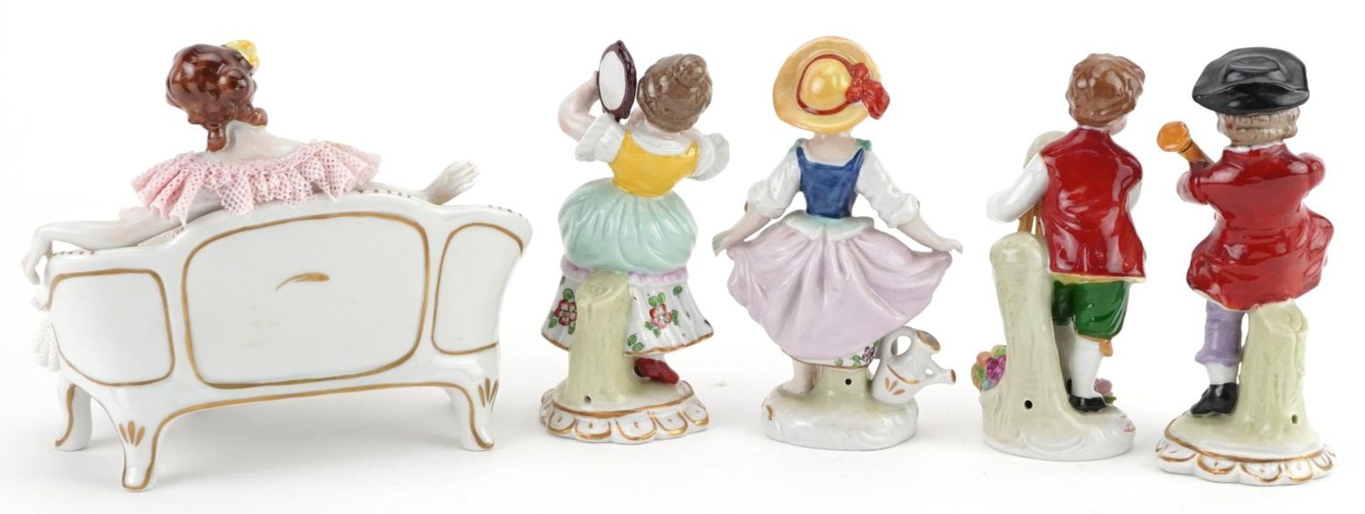 German porcelain comprising four Dresden figurines and a lace figurine in the form of a female on - Image 4 of 5
