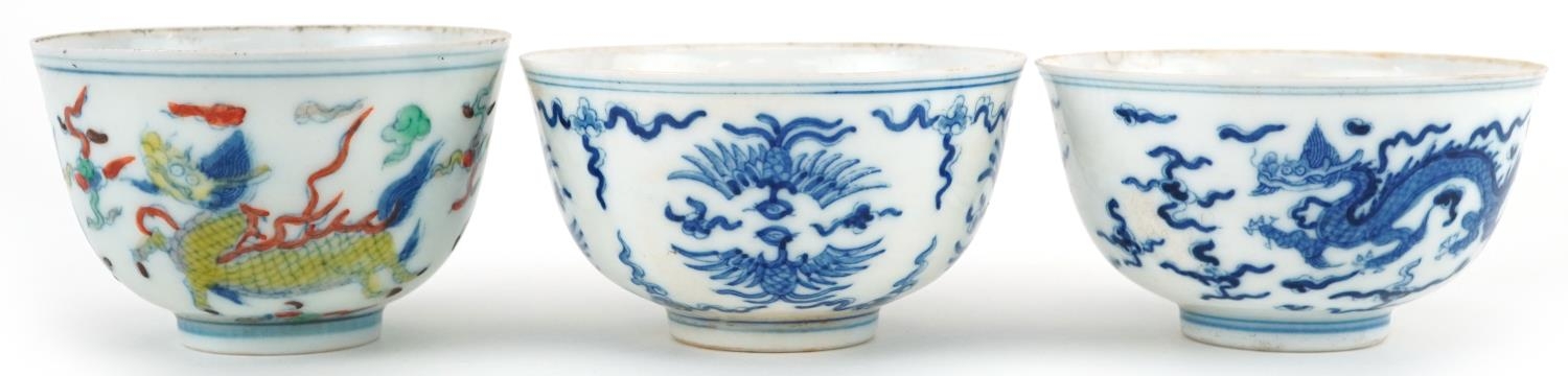 Three Chinese porcelain bowls including a blue and white example hand painted with stylised