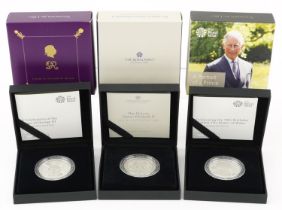 Three United Kingdom silver proof five pound coins by The Royal Mint with cases and boxes,