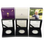 Three United Kingdom silver proof five pound coins by The Royal Mint with cases and boxes,