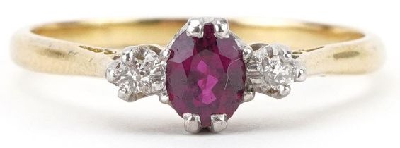 18ct gold ruby and diamond three stone ring, the ruby approximately 5.50mm x 4.50mm x 2.80mm deep,
