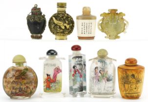 Nine Chinese snuff bottles including a green and russet jade archaic style example, carved bone