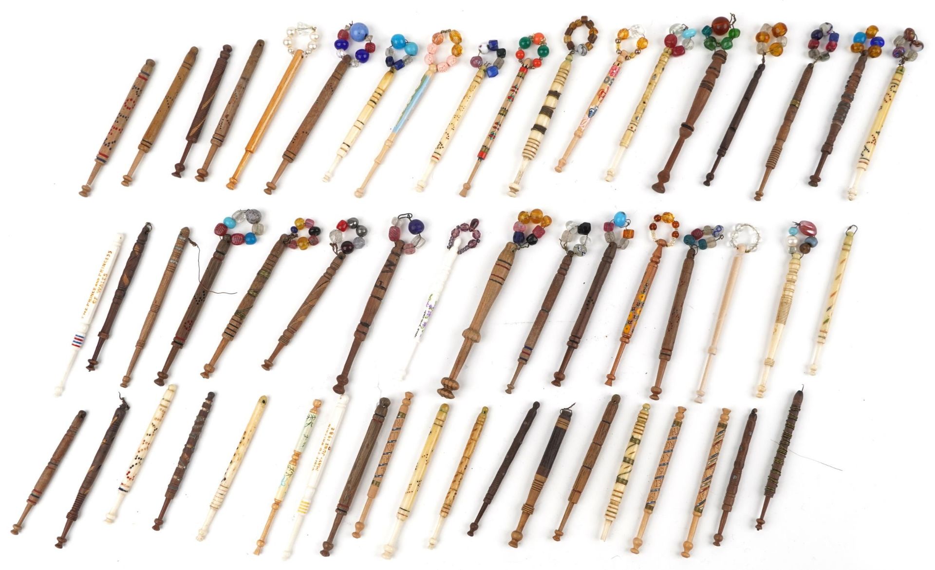 Collection of sewing interest carved bone and hardwood lace making bobbins with beads