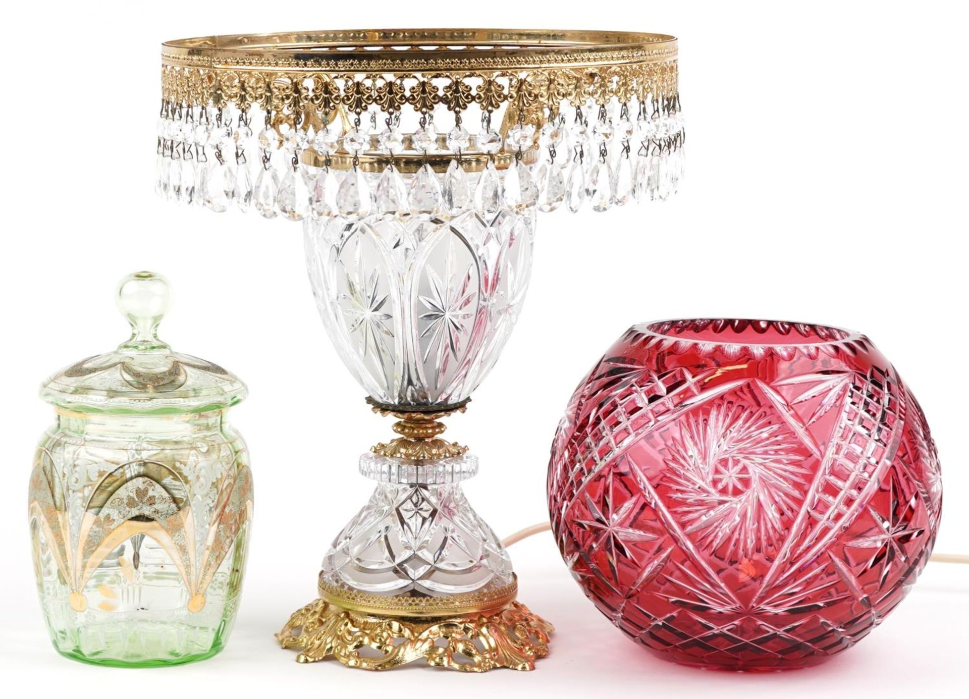 Glassware including Bohemian ruby overlaid cut glass vase and a glass and brass lamp with drops, the