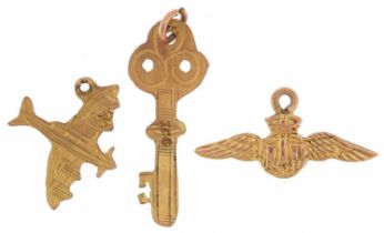 Three 9ct gold charms, some military interest, in the form of RAF wings, aeroplane and key, the