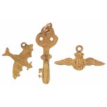 Three 9ct gold charms, some military interest, in the form of RAF wings, aeroplane and key, the