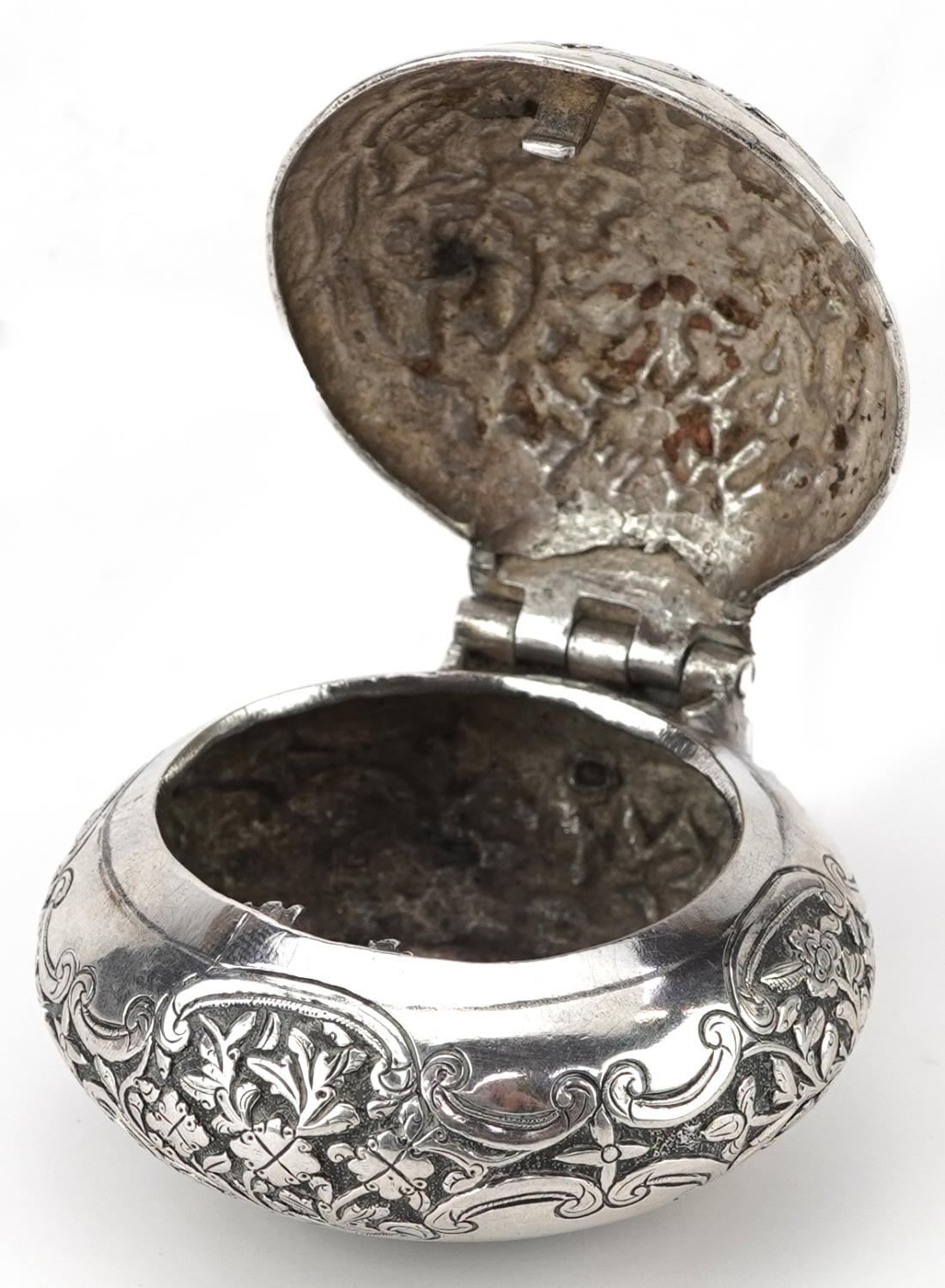 Tibetan unmarked silver bun shaped box with hinged lid profusely embossed with flowers and - Image 3 of 5