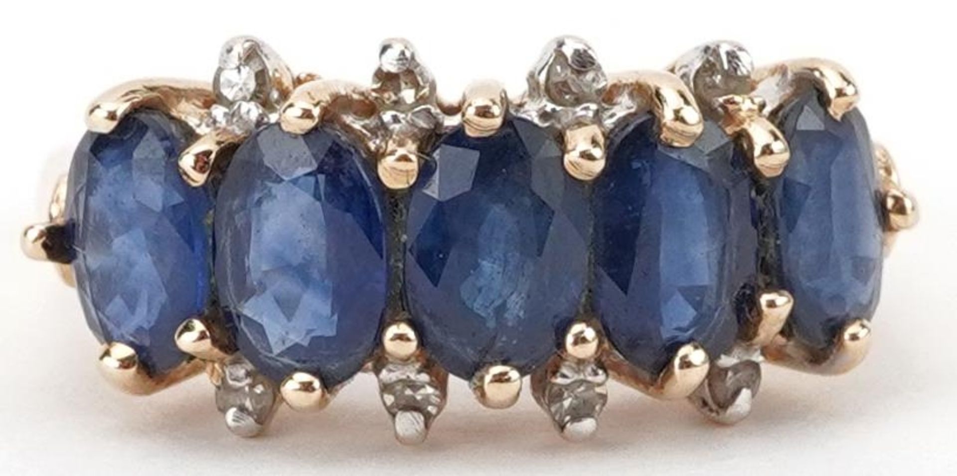 14K gold sapphire and diamond ring set with five sapphires and eight diamonds, each sapphire