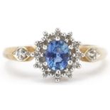 9ct gold sapphire and diamond cluster ring with diamond set shoulders, the sapphire approximately