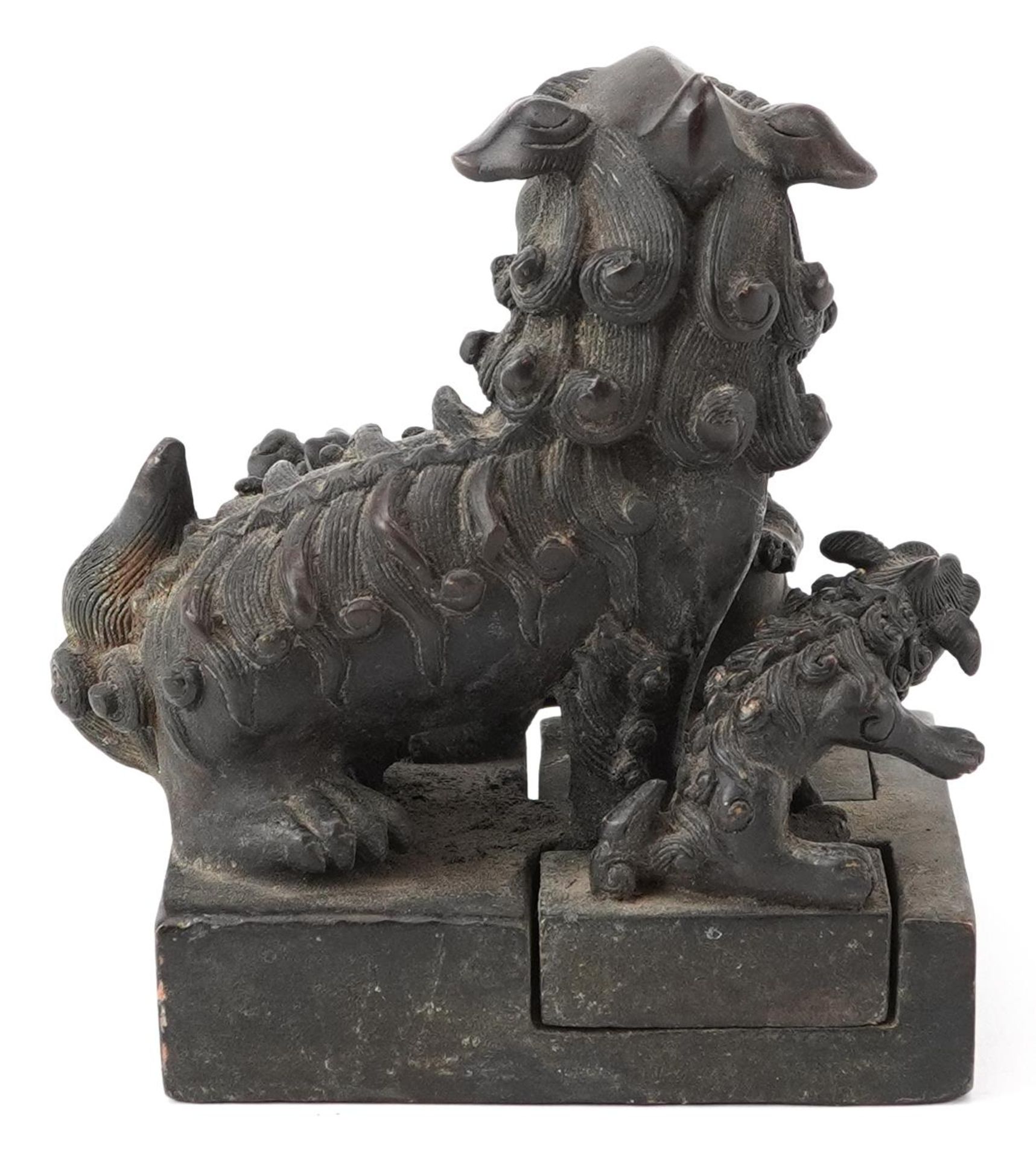 Set of four Chinese patinated bronze interlocking desk seals in the form of qilins, 12cm high - Image 4 of 8